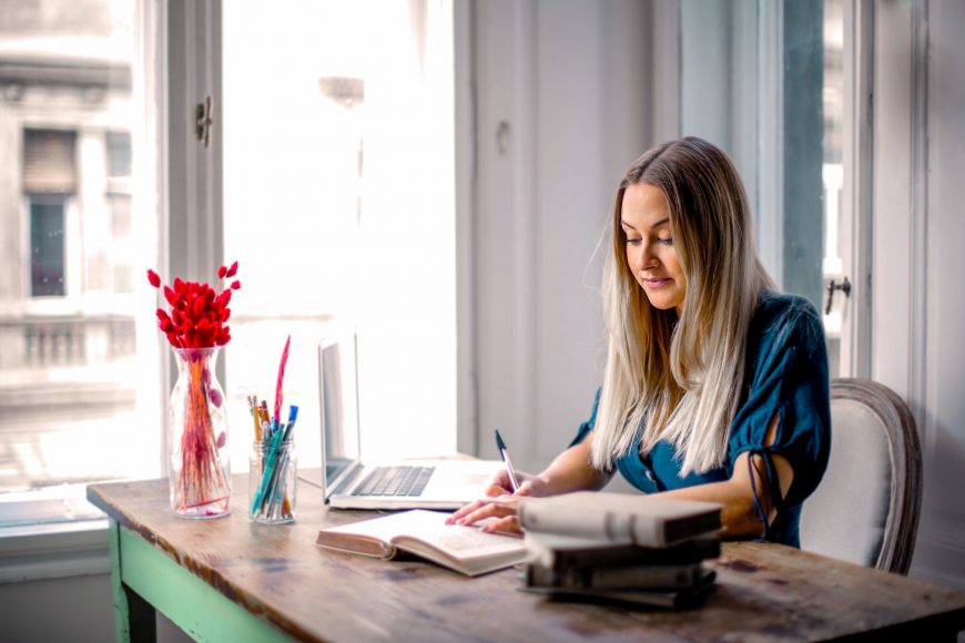 woman-in-blue-long-sleeve-shirt-sitting-at-the-table-working-3767388