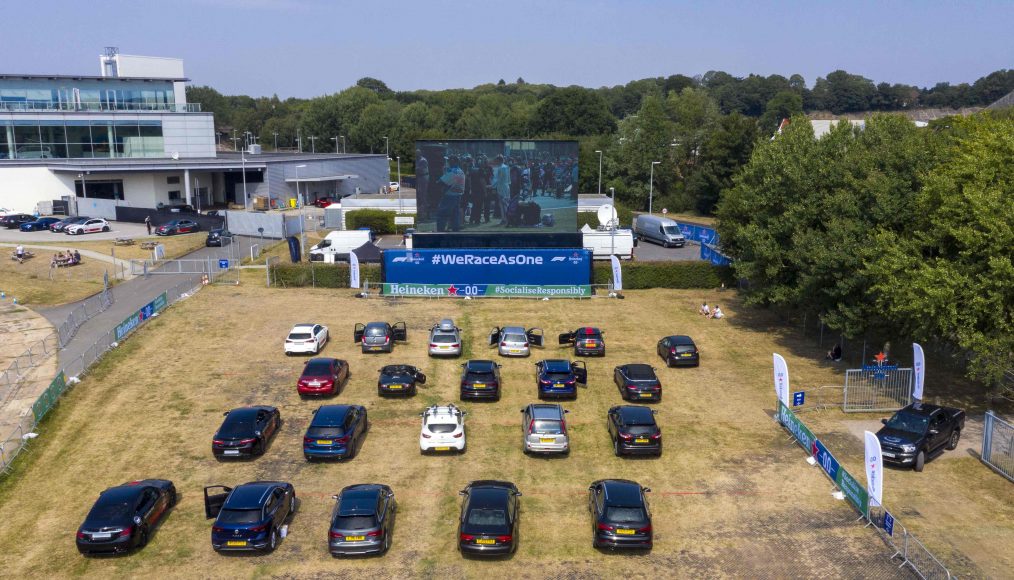 Aerial shots of guests enjoying a socially responsible drive-in screening experience, hosted by Heineken0.0, showing the Formula 1, 70th Anniversary Grand Prix Race, Weybridge. PA Photo. Picture date: Sunday August 9, 2020. As well as F1 fans, healthcare workers were amongst those invited by Heineken as a token of gratitude for all their support over the pandemic. They were given a passenger experience around the Mercedes-Benz World track with an expert racing driver and then watched the race in full. Photo credit should read: Steve Parsons/PA Wire