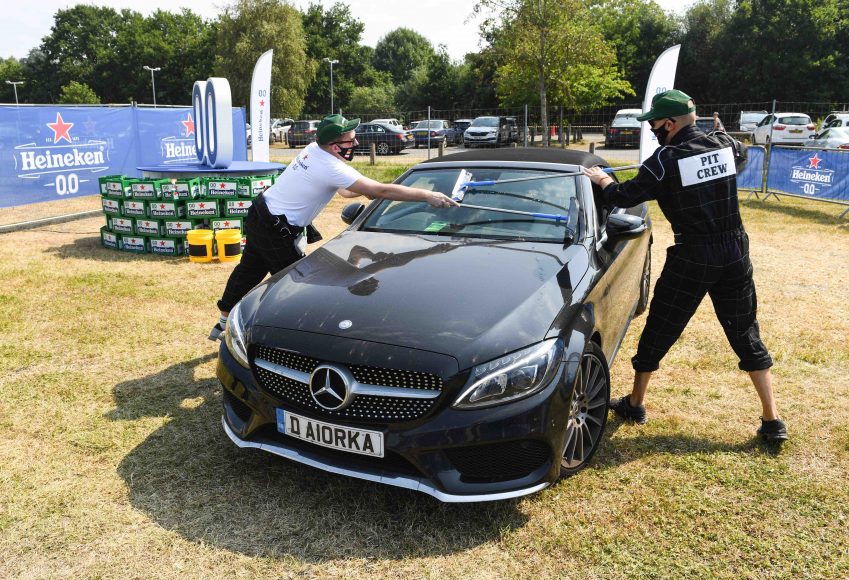 Guests enjoy a drive-in screening experience, hosted by Heineken 0.0%, showing the 70th Anniversary Grand Prix Race, Weybridge. PA Photo. Picture date: Sunday August 9, 2020. The guests are primarily healthcare workers, which Heineken selected to say thank you for their hard work over a difficult few months due to the COVID-19 pandemic. They were given a passenger experience around the Mercedes-Benz World track with an expert racing driver and then watch the race in full. Photo credit should read: Doug Peters/PA Wire