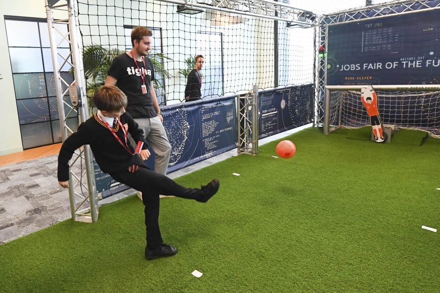 Barney,Year 8, from Prendergast Ladywell School, takes a penalty against an AI goalkeeper, at Amazon’s Jobs Fair of the Future event, marking the launch of the ‘Alexa Young Innovator Challenge’, an AI-inspired educational programme for secondary school pupils, at their offices in London. Issue date: Tuesday November 8, 2022. PA Photo. New research reveals that computer science and AI related roles could contribute £71 billion a year to the UK economy. Photo credit: Matt Crossick/PA Wire.