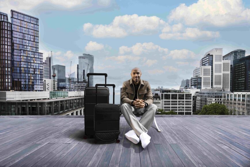 Kabuto x Thierry Henry HERO Lifestyle Image Thierry Henry on London rooftop LANDSCAPE with Kabuto x Thierry Henry Expandable Leather Carry-on and Trunk Large